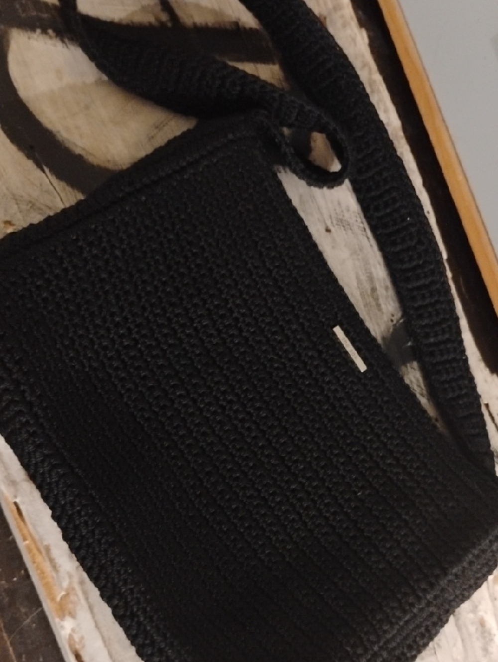 The Sak Black Crochet Shoulder Bag with Silver Logo Plaque